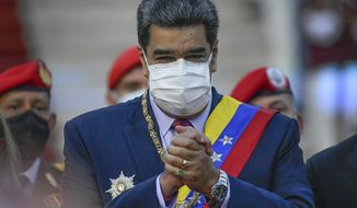 Venezuela&#39;s President Nicolas Maduro clasps his hands as he arrives to deliver his State of the Nation address at the National Assembly in Caracas, Venezuela, Saturday, Jan. 15, 2022. (AP Photo/Matias Delacroix)