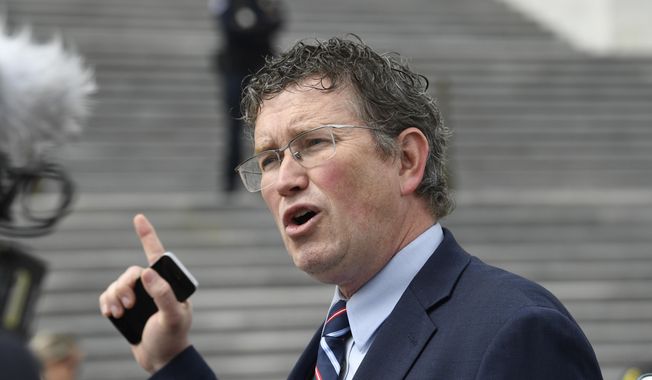 Rep. Thomas Massie, R-Ky., talks to reporters before leaving Capitol Hill in Washington, on Friday, March 27, 2020. (AP Photo/Susan Walsh, File)