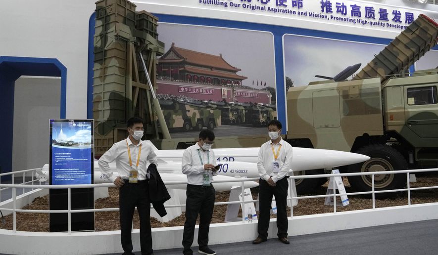 Workers wearing masks stand near missiles produced by China Aerospace Science and Industry Corp.displayed during the 13th China International Aviation and Aerospace Exhibition, also known as Airshow China 2021 on Tuesday, Sept. 28, 2021 in Zhuhai in southern China&#39;s Guangdong province. China on Friday, Jan. 21, 2022 criticized Washington for imposing sanctions on Chinese companies the U.S. says exported missile technology and accused the United States of hypocrisy for selling nuclear-capable cruise missiles. (AP Photo/Ng Han Guan)