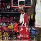 Maryland guard Hakim Hart, center, drops a dunk in front of Illinois Fighting guard Trent Frazier (1) during the first half of an NCAA college basketball game, Friday, Jan. 21, 2022, in College Park, Md. (AP Photo/Julio Cortez)