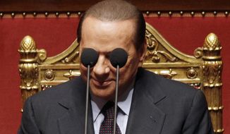 FILE - Italian Premier Silvio Berlusconi is framed by microphones prior to deliver his speech at the Italian Senate, Thursday, Sept. 30, 2010. Italy is poised to elect a new president, a figure who is supposed to serve as the nation&#39;s moral compass and foster unity by being above the political fray. Silvio Berlusconi thinks he fits the bill. (AP Photo/Alessandra Tarantino, File)