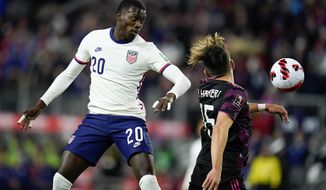 United States&#x27; Tim Weah, left, goes up for the ball against Mexico&#x27;s Hector Herrera during the first half of a FIFA World Cup qualifying soccer match Nov. 12, 2021, in Cincinnati. Weah, Jordan Morris, Sergiño Dest and Gyasi Zardes returned from injuries to make the U.S. roster ahead of the next three World Cup qualifiers. (AP Photo/Julio Cortez, File)  **FILE**