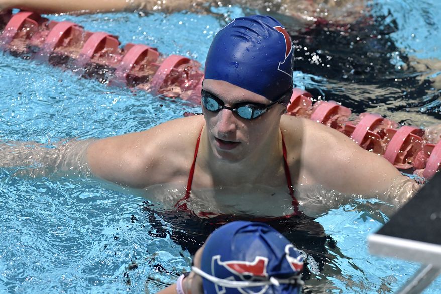 Transgender swimmer Lia Thomas, center with teammates during Warm up laps before a meet with Harvard on Saturday, Jan. 22, 2022, at Harvard University in Cambridge, Mass. (AP Photo/Josh Reynolds)
