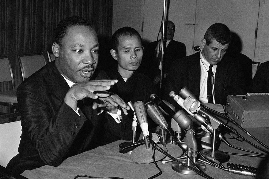 Dr. Martin Luther King Jr., left, appearing in a Chicago news conference with Thich Nhat Hanh, a Buddhist monk from Viet Nam, suggests a halt in bombing of Viet Nam, May 31, 1966. (AP Photo/Edward Kitch, File)