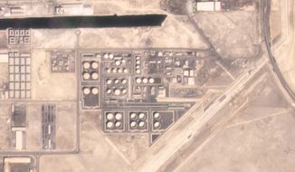 In this satellite image provided by Planet Labs PBC, an Abu Dhabi National Oil Co. fuel depot in the Mussafah neighborhood of Abu Dhabi, United Arab Emirates, is seen Saturday, Jan. 15, 2022, before being targeted in an attack days later. (Planet Labs PBC via AP)