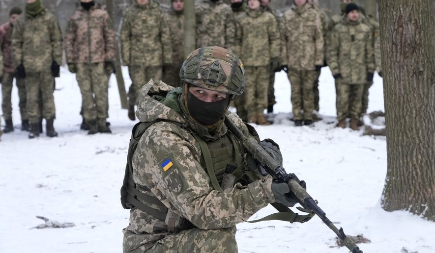 An instructor trains members of Ukraine&#x27;s Territorial Defense Forces, volunteer military units of the Armed Forces, in a city park in Kyiv, Ukraine, Saturday, Jan. 22, 2022. Dozens of civilians have been joining Ukraine&#x27;s army reserves in recent weeks amid fears about Russian invasion. (AP Photo/Efrem Lukatsky)