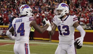 Buffalo Bills wide receiver Gabriel Davis (13) celebrates with teammate Stefon Diggs (14) after catching a 75-yard touchdown pass during the second half of an NFL divisional round playoff football game against the Kansas City Chiefs, Sunday, Jan. 23, 2022, in Kansas City, Mo. (AP Photo/Charlie Riedel)