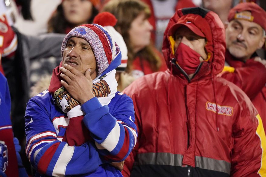 Fans watch from the stands during the second half of an NFL divisional round playoff football game between the Kansas City Chiefs and the Buffalo Bills, Sunday, Jan. 23, 2022, in Kansas City, Mo. (AP Photo/Charlie Riedel)