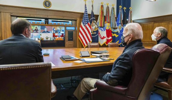 In this photo released by The White House, President Joe Biden, center, meets virtually with his national security team and senior officials to discuss Russia&#39;s aggressive actions toward Ukraine, Saturday, Jan. 22, 2022, at Camp David, Md. (The White House via AP)