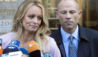 Adult film actress Stormy Daniels, accompanied by her attorney, Michael Avenatti, right, talks to the media as she leaves federal court, on April 16, 2018 in New York. Avenatti, the once high-profile California attorney who regularly taunted then-President Donald Trump during frequent television appearances, was introduced Thursday, Jan. 20, 2022, to prospective jurors who will decide whether he cheated porn star Stormy Daniels out of book-deal proceeds. (AP Photo/Mary Altaffer, File)