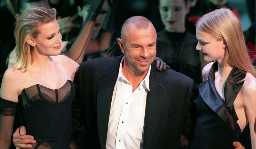 French fashion designer Thierry Mugler on the catwalk with unidentified models after the presentation of his 1998-99 fall-winter ready-to-wear collection presented in Paris on March 15, 1998. Mugler, whose dramatic designs were worn by celebrities like Madonna, Lady Gaga and Cardi B, has died. He was 73. A post all in black on his official Instagram account said he died Sunday, Jan. 23, 2022 and “May his soul Rest In Peace.&amp;quot; It did not give a cause of death. (AP Photo/Remy de la Mauviniere, File)