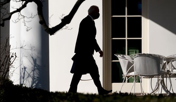 President Joe Biden arrives at the White House in Washington, Monday, Jan. 24, 2022, after spending the weekend at Camp David, Md. (AP Photo/Andrew Harnik)