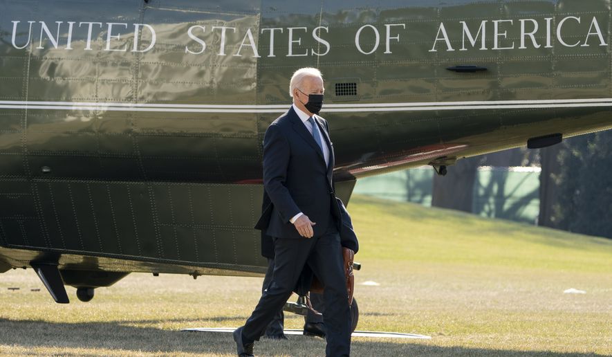 President Joe Biden arrives at the White House in Washington, Monday, Jan. 24, 2022, after spending the weekend at Camp David, Md. (AP Photo/Andrew Harnik)