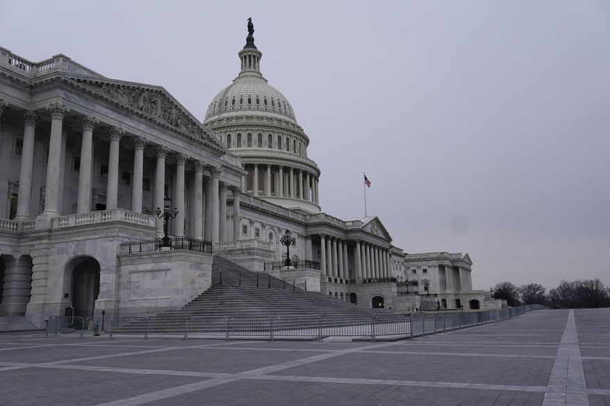 The U.S. Capitol seen in the evening in Washington, Monday, Jan. 24, 2022, (AP Photo/Mariam Zuhaib)