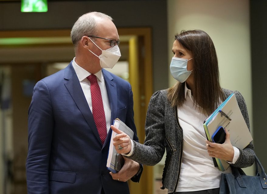 Ireland&#39;s Foreign Minister Simon Coveney, left, speaks with Belgium&#39;s Foreign Minister Sophie Wilmes during a meeting of EU foreign ministers at the European Council building in Brussels, Monday, Jan. 24, 2022. (AP Photo/Virginia Mayo)
