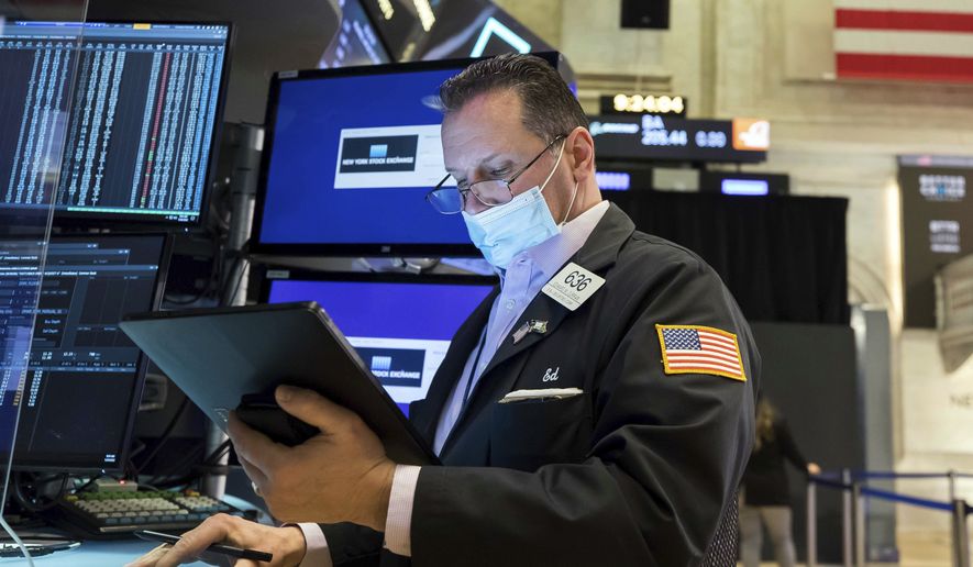 In this photo provided by the New York Stock Exchange, trader Edward Curran works on the floor, Monday, Jan. 24, 2022. The Dow Jones Industrial Average dropped more than 1,000 points Monday as financial markets buckled in anticipation of inflation-fighting measures from the Federal Reserve and fretted over the possibility of conflict between Russia and Ukraine. (Courtney Crow/New York Stock Exchange via AP)