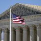 An American flag waves in front of the Supreme Court building on Capitol Hill in Washington, Nov. 2, 2020. (AP Photo/Patrick Semansky, File)
