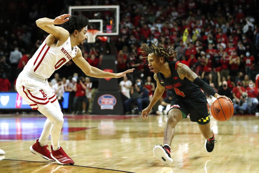 Maryland guard Fatts Russell (4) looks to drive to the basket as Rutgers guard Geo Baker (0) defends during the first half of an NCAA college basketball game in Piscataway, N.J., Tuesday,, Jan. 25, 2022. (AP Photo/Noah K. Murray)