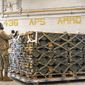 In this image provided by the U.S. Air Force, airmen and civilians from the 436th Aerial Port Squadron palletize ammunition, weapons and other equipment bound for Ukraine during a foreign military sales mission at Dover Air Force Base, Del., Jan. 21, 2022. (Mauricio Campino/U.S. Air Force via AP)