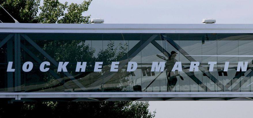 A man walks past a Lockheed Martin logo as he walks through a section of the company&#39;s chalet bridging a road at Farnborough International Airshow in Farnborough, southern England, Wednesday July 19, 2006. The Biden administration is suing to block a Lockheed Martin acquisition that it says would limit competition among companies that supply missiles to the Pentagon. The Federal Trade Commission said Tuesday, Jan. 25, 2022 that the $4.4 billion deal would eliminate the last independent U.S. supplier of key missile parts. (AP Photo/Matt Dunham, FILE)