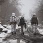 FILE - Ukrainian soldiers walks at the line of separation from pro-Russian rebels near Katerinivka, Donetsk region, Ukraine, Tuesday, Dec 7, 2021. Germany&#39;s refusal to join other NATO members in supplying Ukraine with weapons has frustrated allies and prompted some to question Berlin&#39;s resolve in standing up to Russia. (AP Photo/Andriy Dubchak)