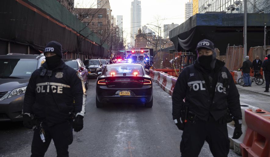 New York City Police Department officers stand in New York, Tuesday, Jan. 25, 2022. (AP Photo/Yuki Iwamura)