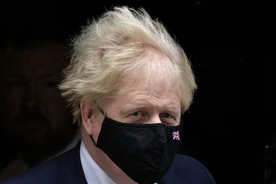 Britain's Prime Minister Boris Johnson leaves 10 Downing Street to attend the weekly Prime Ministers' Questions session in parliament in London, Wednesday, Jan. 26, 2022. Johnson is bracing for the conclusions of an investigation into allegations of lockdown-breaching parties, a document that could help him end weeks of scandal and discontent, or bring his time in office to an abrupt close. (AP Photo/Kirsty Wigglesworth)