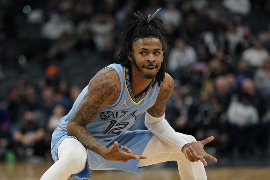 Memphis Grizzlies guard Ja Morant (12) reacts after scoring against the San Antonio Spurs during the second half of an NBA basketball game, Wednesday, Jan. 26, 2022, in San Antonio. (AP Photo/Eric Gay)