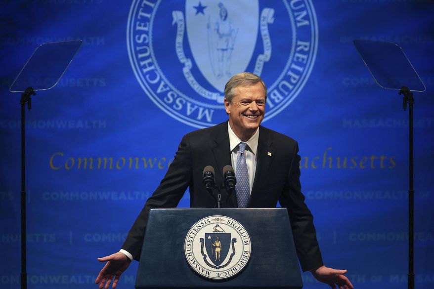 Massachusetts Gov. Charlie Baker leans forward and says, "I miss you, man!" referencing former Boston Mayor and current Secretary of Labor Marty Walsh as he delivers the State of the Commonwealth address, Tuesday, Jan. 25, 2022, at the Hynes Convention Center in Boston. (Barry Chin/The Boston Globe via AP)