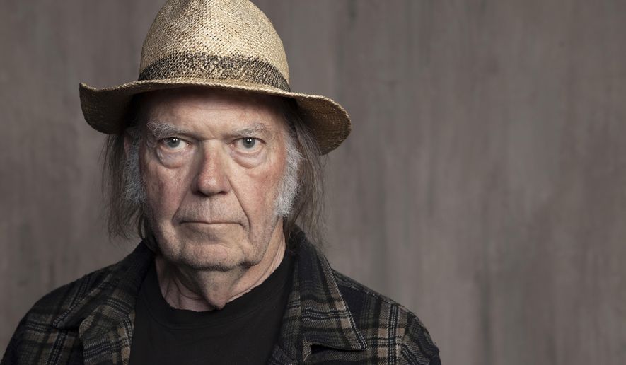Neil Young poses for a portrait in Santa Monica, Calif. on Sept. 9, 2019. Spotify says it will grant the veteran rocker&#39;s request to remove his music from its streaming platform. Young made the request as a protest to what he called the company&#39;s decision to allow COVID-19 misinformation to spread on its service. (Photo by Rebecca Cabage/Invision/AP, File)