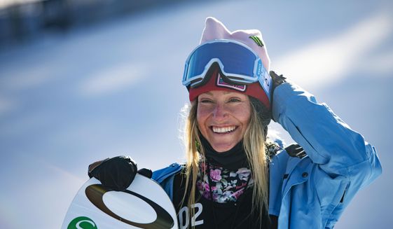 Jamie Anderson stands at the bottom of the big air course after winning her second gold medal during the Winter X Games on Sunday, Jan. 31, 2021, in Aspen, Colo. Even in a sport filled with nonconformists, Anderson stands out. The 31-year-old from South Lake Tahoe, California, is one of the most thoughtful people in her business.  (Kelsey Brunner/The Aspen Times via AP, File) **FILE**