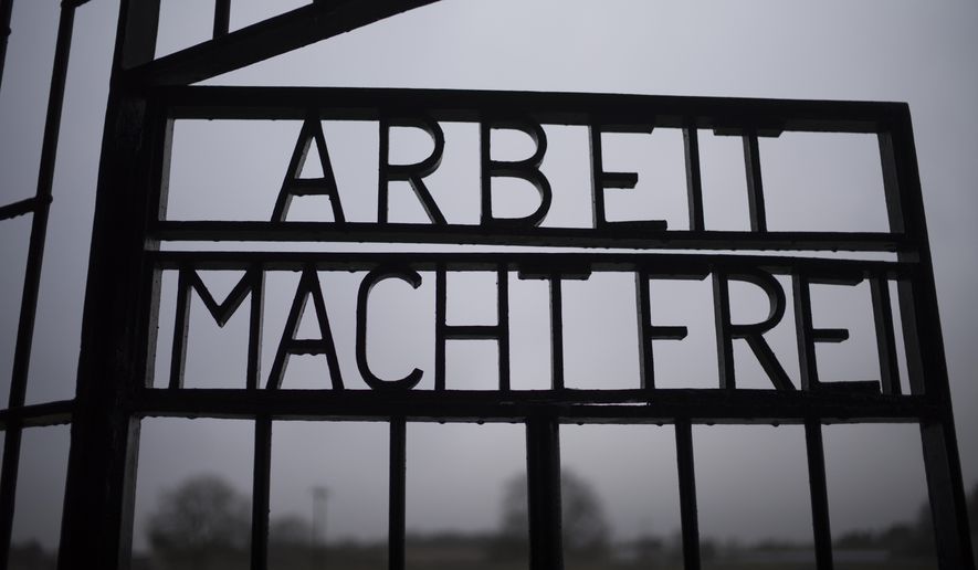 The gate of the Sachsenhausen Nazi death camp with the phrase &#39;Arbeit macht frei&#39; (work sets you free) stands open in Oranienburg, about 30 kilometers (18 miles) north of Berlin, Germany, Tuesday, Jan. 25, 2022. On Thursday Jan. 27, 2022 the International Holocaust Remembrance Day marks the liberation of the Auschwitz Nazi death camp on Jan. 27, 1945. (AP Photo/Markus Schreiber)