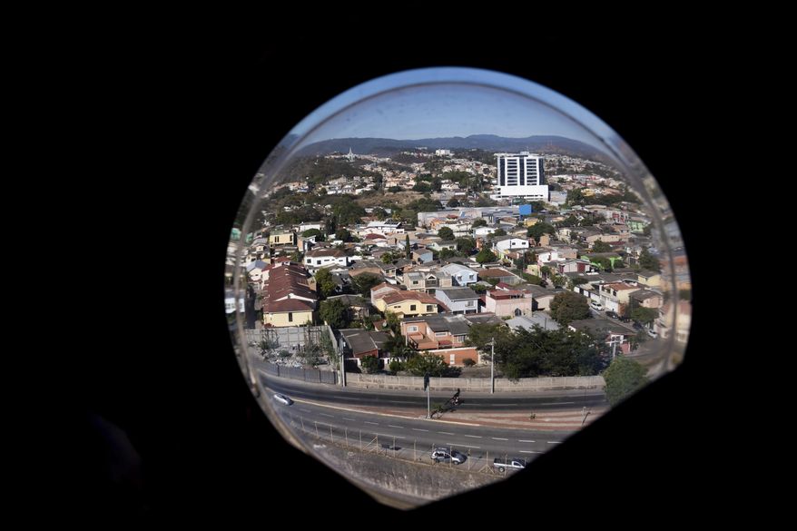 This photo shows the view out of a chinook window of Tegucigalpa, Honduras on Thursday, Jan. 27, 2022. (Erin Schaff/The New York Times via AP, Pool)