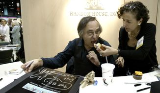 FILE - Artist and author Art Spiegelman gets some help with his lunch from Francoise Mouly, of Random House, Inc., during a signing of Spiegelman&#39;s new book &amp;quot;In the Shadow of No Towers&amp;quot; at the Book Expo America convention, Saturday, June 5, 2004, in Chicago.  A Tennessee school district has voted to ban a Pulitzer Prize winning graphic novel about the Holocaust due to “inappropriate language” and an illustration of a nude woman. That&#39;s according to minutes from the McMinn County School Board meeting on Jan. 10, 2022.  Board members voted to remove “Maus,” a graphic novel by Art Spiegelman. (AP Photo/Brian Kersey, File)