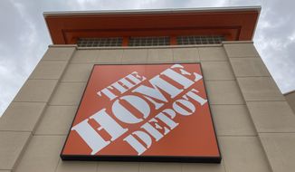 A Home Depot logo sign hangs on its facade, Friday, May 14, 2021, in North Miami, Fla. (AP Photo/Wilfredo Lee, File)
