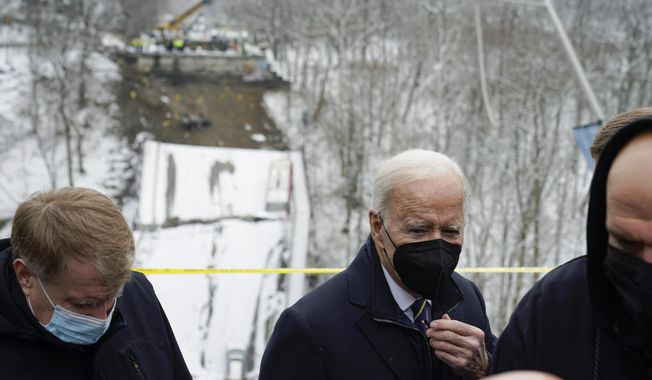 President Joe Biden visits the site where the Fern Hollow Bridge collapsed Friday, Jan. 28, 2022, in Pittsburgh&#x27;s East End. (AP Photo/Andrew Harnik)