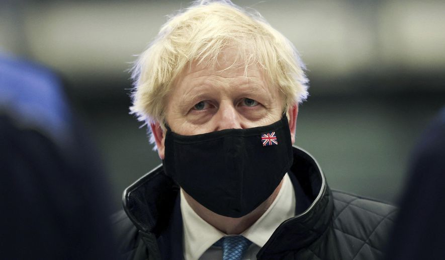Britain&#x27;s Prime Minister Boris Johnson looks on, during a visit to RAF Valley, in Anglesey, North Wales, Thursday, Jan. 27, 2022. (Carl Recine/Pool Photo via AP)