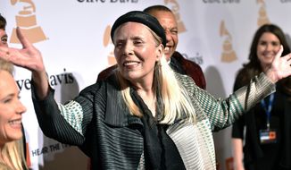 FILE - Joni Mitchell arrives at the 2015 Clive Davis Pre-Grammy Gala in Beverly Hills, Calif. Feb. 7, 2015. Joni Mitchell said Friday, Jan. 28, 2022 she seeks to remove all of her music in Spotify in solidarity with Neil Young, who ignited a protest against the streaming service for airing a podcast that featured a figure who has spread misinformation about the coronavirus. (Photo by John Shearer/Invision/AP, File)