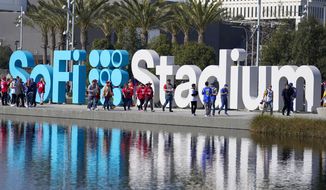 Fans make their way to SoFi Stadium before the NFC Championship NFL football game between the Los Angeles Rams and the San Francisco 49ers Sunday, Jan. 30, 2022, in Inglewood, Calif. (AP Photo/Marcio Jose Sanchez)
