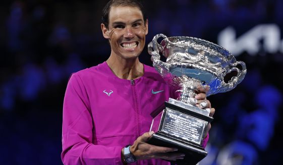 Rafael Nadal of Spain holds the Norman Brookes Challenge Cup after defeating Daniil Medvedev of Russia in the men&#39;s singles final at the Australian Open tennis championships in Melbourne, Australia, early Monday, Jan. 31, 2022. (AP Photo/Hamish Blair)