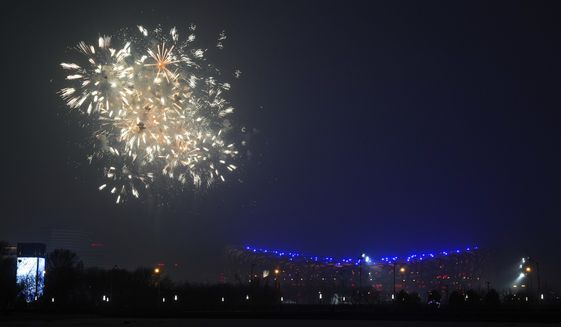 Fireworks explode over the Beijing skyline near the iconic Bird&#39;s Nest Stadium during a rehearsal for the opening ceremony of the 2022 Winter Olympics to be held in Beijing, Sunday, Jan. 30, 2022. (AP Photo/Andy Wong)