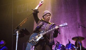 FILE - In this May 25, 2019, photo, Neil Young performs at the BottleRock Napa Valley Music Festival at Napa Valley Expo in Napa, Calif. Following protests of Spotify kicked off by Young over the spread of COVID-19 vaccine misinformation, the music streaming service said Sunday, Jan. 30, 2022, that it will add content advisories before podcasts discussing the virus. The singer on Wednesday, Jan. 26, had his music removed from Spotify after the tech giant declined to remove episodes of “The Joe Rogan Experience,” which has been criticized for spreading virus misinformation. (Photo by Amy Harris/Invision/AP, File)