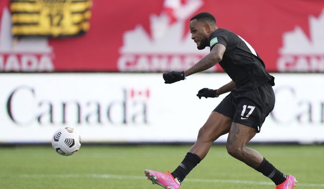 Canada&#x27;s Cyle Larin scores against the United States during the first half of a World Cup soccer qualifier in Hamilton, Ontario, Sunday, Jan. 30, 2022. (Nathan Denette/The Canadian Press via AP)