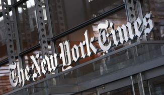 A sign for The New York Times hangs above the entrance to its building, Thursday, May 6, 2021 in New York. On Monday, Jan. 31, 2022, the Times announced it has bought Wordle, the free online word game that has exploded in popularity in a matter of months. (AP Photo/Mark Lennihan)