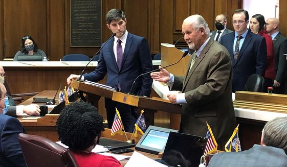 Indiana state Rep. Chuck Moseley, D-Portage, right, speaks during a debate with state Rep. Tim Wesco, R-Osceola, on Monday, Jan. 31, 2022, at the Indiana Statehouse in Indianapolis. The Indiana House on Monday approved a bill sponsored by Wesco that would tighten the state law on mail-in voting. (AP Photo/Tom Davies)