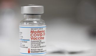 A vial of the Moderna COVID-19 vaccine is displayed on a counter at a pharmacy in Portland, Ore., Monday, Dec. 27, 2021. U.S. regulators have granted full approval to Moderna’s COVID-19 vaccine after reviewing additional data on its safety and effectiveness. The decision Monday, Jan. 31, 2022, by the Food and Drug Administration comes after many tens of millions of Americans have already received the shot under its original emergency authorization. Full approval means FDA has completed the same rigorous, time-consuming review for Moderna’s shot as dozens of other long-established vaccines. (AP Photo/Jenny Kane)