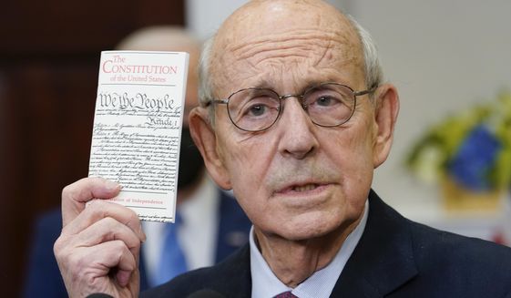 Supreme Court Associate Justice Stephen Breyer holds up a copy of the United States Constitution as he announces his retirement in the Roosevelt Room of the White House in Washington, Thursday, Jan. 27, 2022. Democratic Rep. Jim Clyburn and Republican Sen. Lindsey Graham say it would be good if the person named to replace retiring Breyer doesn’t have an Ivy League degree. (AP Photo/Andrew Harnik, File)