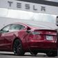 A 2021 Model 3 sedan sits in a near-empty lot at a Tesla dealership in Littleton, Colo. June 27, 2021. Tesla is recalling nearly 54,000 vehicles because their “Full Self-Driving” software lets them roll through stop signs without coming to a complete halt. Documents posted Tuesday, Feb. 1, 2022, by U.S. safety regulators say that Tesla will disable the feature with an over-the-internet software update. (AP Photo/David Zalubowski) **FILE**
