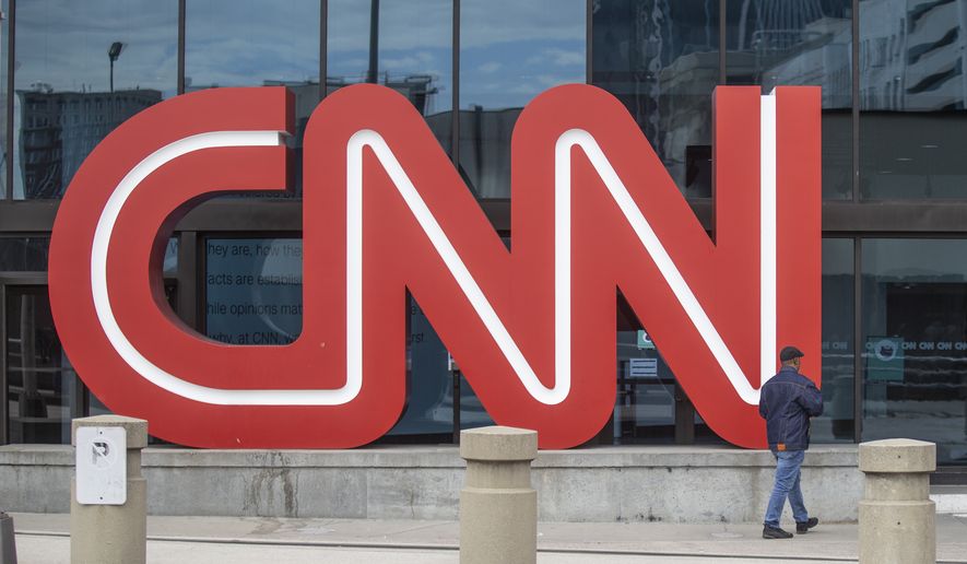 The CNN logo is displayed at the entrance to the CNN Center in Atlanta on Wednesday, Feb. 2, 2022. CNN President Jeff Zucker has abruptly resigned Wednesday after acknowledging a consensual relationship with another network executive. (AP Photo/Ron Harris)