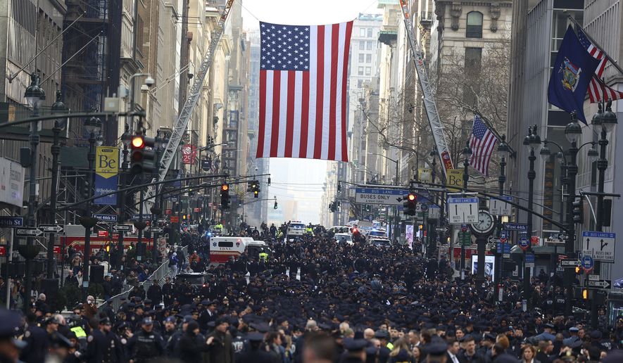 New York Police officers begin to arrive along Fifth Avenue outside St. Patrick&#x27;s Cathedral for Officer Wilbert Mora&#x27;s funeral, Wednesday, Feb. 2, 2022, in New York. For the second time in under a week, police converged on New York City&#x27;s St. Patrick&#x27;s Cathedral to pay tribute to a young officer gunned down while answering a call for help in Harlem. Mora was shot along with Officer Jason Rivera on Jan. 22 while responding to a call about a domestic argument in an apartment. (AP Photo/Yuki Iwamura)